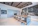 Modern kitchen featuring a marble backsplash, large island with seating, and sleek cabinetry for ample storage at 18725 Jiretz Rd, Odessa, FL 33556