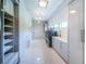 Clean and spacious laundry room featuring side by side machines, storage cabinets, and bright lighting at 18725 Jiretz Rd, Odessa, FL 33556