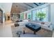 Open-concept living area with contemporary furnishings, large windows, and seamless flow into the dining space at 18725 Jiretz Rd, Odessa, FL 33556