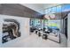 Spacious living room featuring high ceilings, modern lighting, and expansive windows overlooking the waterfront at 18725 Jiretz Rd, Odessa, FL 33556