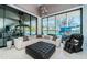 Bright living room with floor to ceiling windows offering scenic views of the outdoor pool area at 18725 Jiretz Rd, Odessa, FL 33556