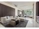 A modern living room boasting a gray sectional sofa, contemporary design, and lovely lake views at 18725 Jiretz Rd, Odessa, FL 33556