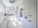 Modern main bathroom with a glass shower, a bench, and marble tile at 18725 Jiretz Rd, Odessa, FL 33556