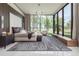 Modern main bedroom with large windows overlooking the water and features a sitting area and luxury finishes at 18725 Jiretz Rd, Odessa, FL 33556