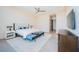 Bright main bedroom with plush rug, king bed with upholstered headboard, and sleek modern furnishings at 18725 Jiretz Rd, Odessa, FL 33556