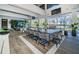 Spacious outdoor kitchen with bar seating, a built-in grill, and picturesque views of the surrounding lake at 18725 Jiretz Rd, Odessa, FL 33556
