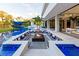 Stunning pool area with a fire pit lounge and outdoor kitchen, perfect for entertaining at 18725 Jiretz Rd, Odessa, FL 33556
