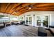Covered porch boasts ample seating and wooden ceilings at 18725 Jiretz Rd, Odessa, FL 33556