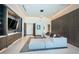 Spacious sitting room with built-in cabinets, grey sectional sofa, and stylish lighting fixture at 18725 Jiretz Rd, Odessa, FL 33556