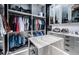 Well-organized closet with shelves, hanging rods, and an island with marble countertop at 18725 Jiretz Rd, Odessa, FL 33556