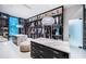 Large walk-in closet with a center island, custom organizers, and overhead lighting at 18725 Jiretz Rd, Odessa, FL 33556