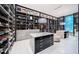 Luxury walk-in closet with custom shelves, drawers, central islands, and contemporary light fixtures at 18725 Jiretz Rd, Odessa, FL 33556