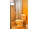 Cozy bathroom featuring tiled shower with shower curtain, toilet, and yellow wall at 2349 Holston Ave, Spring Hill, FL 34608