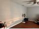 Simple bedroom featuring neutral-toned walls, wood flooring, and a ceiling fan at 2349 Holston Ave, Spring Hill, FL 34608