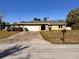 Charming single-story home with stone accents, a covered carport, and an inviting driveway at 2349 Holston Ave, Spring Hill, FL 34608
