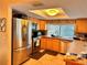 Well-lit kitchen with stainless steel refrigerator, oven, microwave, and a window above the sink at 2349 Holston Ave, Spring Hill, FL 34608