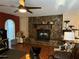 Living room showcasing a stone fireplace and stylish dark wood flooring at 2349 Holston Ave, Spring Hill, FL 34608