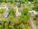 Aerial view of a property showcasing its expansive grounds, mature trees and the house's layout at 24104 Peppermill Dr, Brooksville, FL 34601