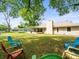 Large backyard with a screened porch and plenty of space to enjoy the outdoors on comfortable chairs at 24104 Peppermill Dr, Brooksville, FL 34601