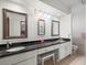 Bright bathroom with a granite countertop, dual sinks, vanity, and toilet at 24104 Peppermill Dr, Brooksville, FL 34601