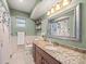 Inviting bathroom with granite countertop vanity, large mirror, and decorative shower curtain at 24104 Peppermill Dr, Brooksville, FL 34601