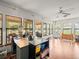 Large bonus room with many windows, wood floors, and bright natural light at 24104 Peppermill Dr, Brooksville, FL 34601