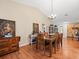 Bright dining room features hardwood floors, high ceilings, and elegant chandelier lighting at 24104 Peppermill Dr, Brooksville, FL 34601