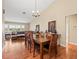 Charming dining room showcases hardwood floors, chandelier lighting, and an adjacent living room at 24104 Peppermill Dr, Brooksville, FL 34601