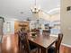 Spacious dining area with hardwood floors, an adjacent stone fireplace, and a blue kitchen at 24104 Peppermill Dr, Brooksville, FL 34601
