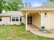 Inviting front porch with a covered entrance, decorative plants, and charming exterior details at 24104 Peppermill Dr, Brooksville, FL 34601