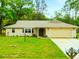 Charming single-story home featuring a well-maintained lawn, attached two-car garage, and traditional architecture at 24104 Peppermill Dr, Brooksville, FL 34601