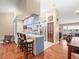 Modern eat-in kitchen features a breakfast bar, wood floors, and adjacent dining and living areas at 24104 Peppermill Dr, Brooksville, FL 34601