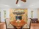 Living room with stone fireplace and views to the outdoors at 24104 Peppermill Dr, Brooksville, FL 34601