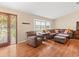 Comfortable living room featuring wood floors, ample seating, and a decorative front door at 24104 Peppermill Dr, Brooksville, FL 34601