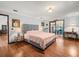 Primary bedroom featuring wood floors and access to the lanai and ensuite bathroom at 24104 Peppermill Dr, Brooksville, FL 34601