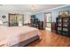 Primary bedroom featuring wood floors, an ensuite bath, and a view to the lanai at 24104 Peppermill Dr, Brooksville, FL 34601