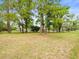 Expansive yard with mature trees offering shade and a serene atmosphere in this lovely home setting at 24104 Peppermill Dr, Brooksville, FL 34601