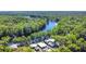 Beautiful aerial view showcasing the home's access to the water surrounded by a dense forest at 28330 Peterson Camp Rd, Brooksville, FL 34601