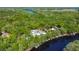 Breathtaking aerial shot showcasing the home's private waterfront location, enveloped by a serene forest at 28330 Peterson Camp Rd, Brooksville, FL 34601