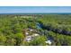 Gorgeous aerial view featuring the home surrounded by trees, near a river, and an open field in the distance at 28330 Peterson Camp Rd, Brooksville, FL 34601