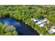 Beautiful aerial view of homes nestled along the tranquil river's edge with lush green surroundings at 28330 Peterson Camp Rd, Brooksville, FL 34601