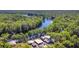 Beautiful aerial view showcasing the home's access to the water surrounded by a dense forest at 28330 Peterson Camp Rd, Brooksville, FL 34601