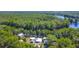 Stunning aerial view of the property surrounded by lush greenery and waterfront access at 28330 Peterson Camp Rd, Brooksville, FL 34601