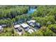 Enchanting aerial captures homes bordering a serene waterfront, fringed by trees, epitomizing nature and comfort at 28330 Peterson Camp Rd, Brooksville, FL 34601