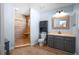 Bathroom featuring a custom shower, updated vanity, and wood-look flooring at 28330 Peterson Camp Rd, Brooksville, FL 34601