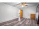 Bright, empty bedroom with wood-look floors, a ceiling fan, and a clean, minimalist aesthetic at 28330 Peterson Camp Rd, Brooksville, FL 34601