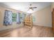 Bedroom featuring wood-look floors, ceiling fan, and natural light at 28330 Peterson Camp Rd, Brooksville, FL 34601