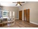 Bedroom featuring wood-look floors, ceiling fan, and bi-fold closet doors at 28330 Peterson Camp Rd, Brooksville, FL 34601