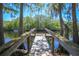 Dock view of the beautiful lake surrounded by mature trees at 28330 Peterson Camp Rd, Brooksville, FL 34601