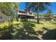 Two-story residence featuring a screened-in porch and charming curb appeal on a sunny day at 28330 Peterson Camp Rd, Brooksville, FL 34601